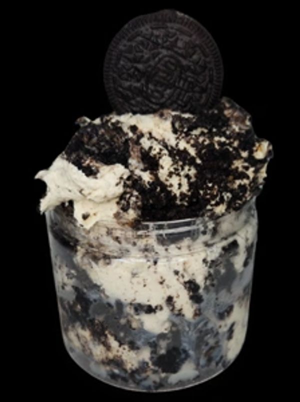 Cookies and cream dessert in a jar with a whole Oreo on top.
