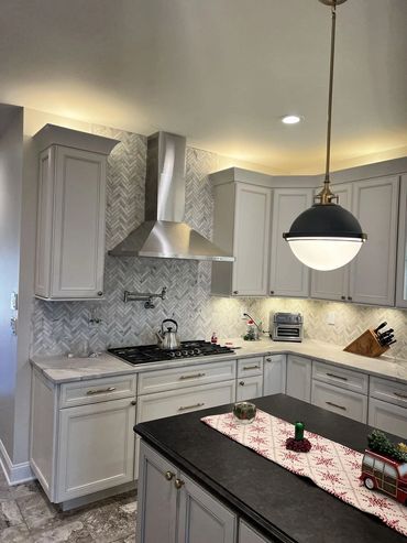 Custom kitchen, complete installation of cabinets, counter tops, tiles, lighting flooring & molding.