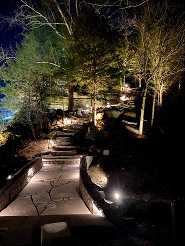 Flagstone walkway with natural rock steps and landscape lighting