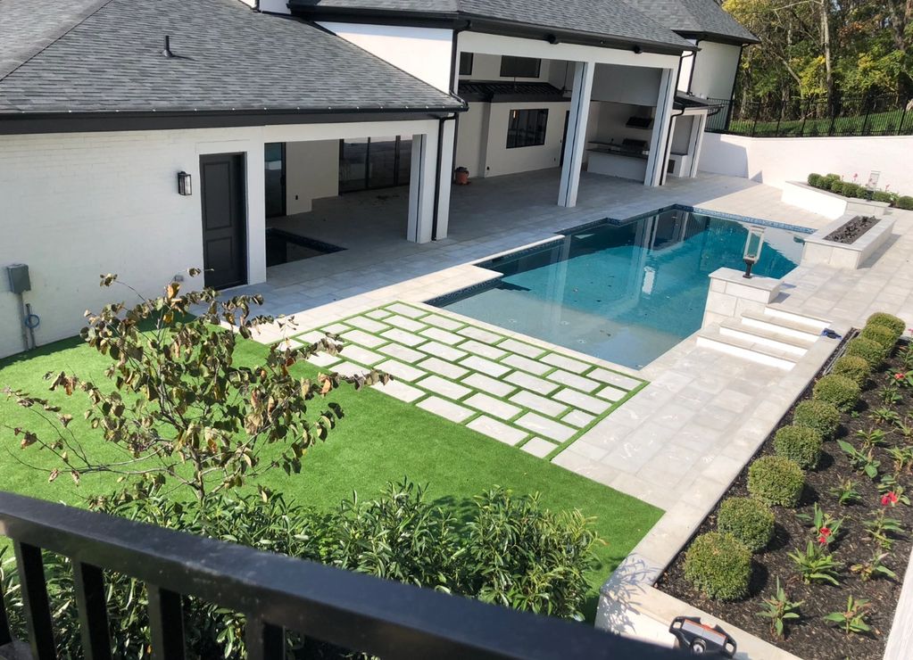 Travertine steps with artificial turf in between.