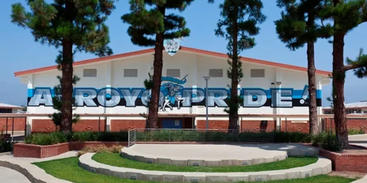 School building with 'ROYAL PRIDE!' mural and horse mascot.