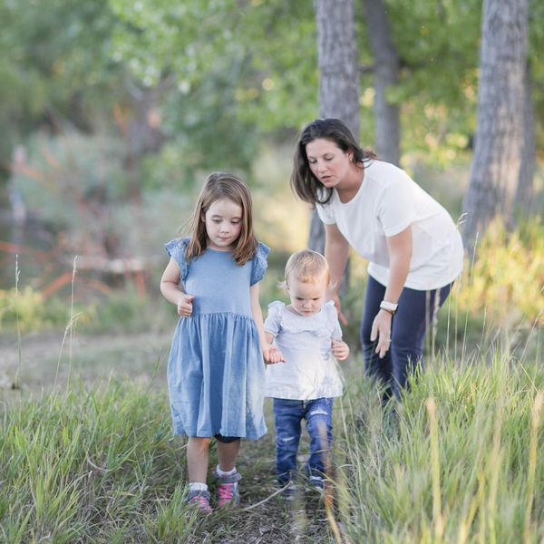 Shelby O'Connor, Occupational Therapist, outdoors with two children on a nature path