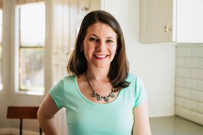 Smiling pediatric therapist in a kitchen