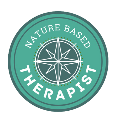 a badge showing a compass stating "Nature Based Therapist"