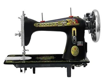 Vintage black Singer sewing machine with decorative gold and red details.