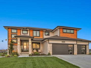 Modern two-story house with a large garage.