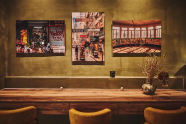 Cozy wooden table with urban photography on wall.