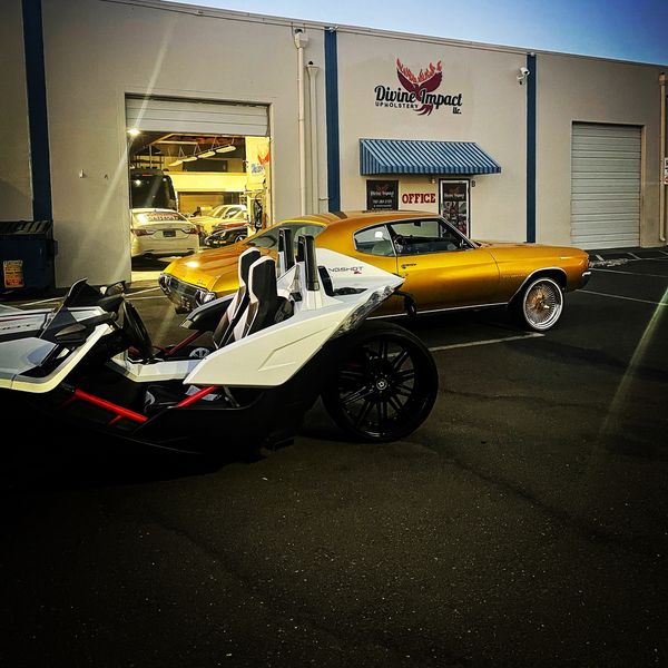 A yellow car parked in front of a building
