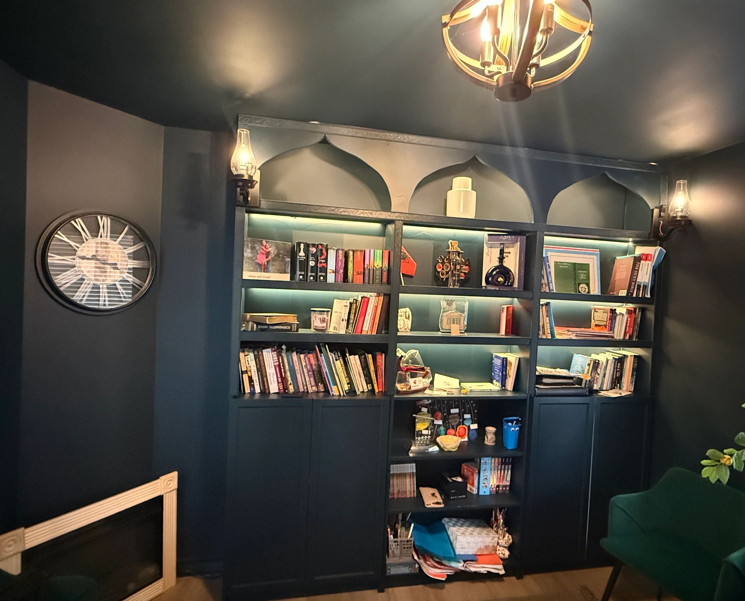 Cozy dark study room with bookshelf and vintage clock.