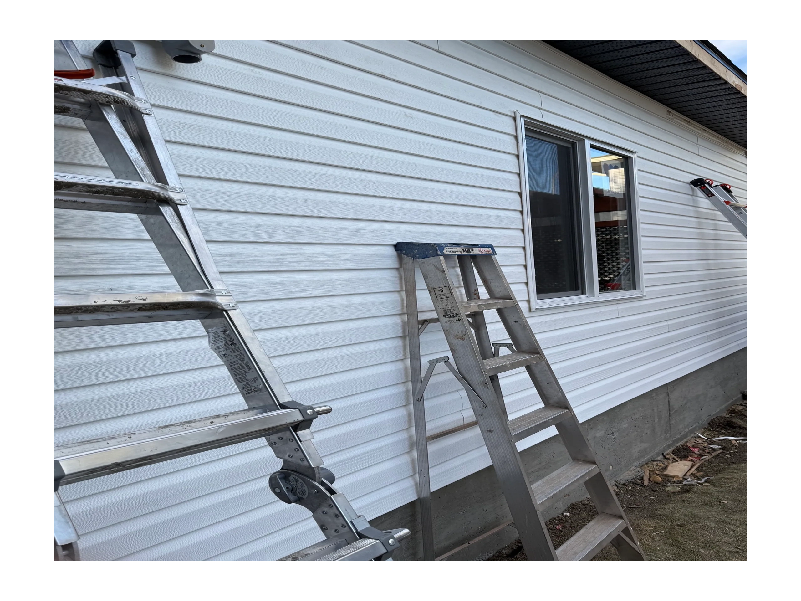 Completed garage construction with vinyl siding and window in Calgary
