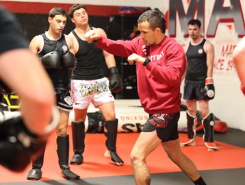 Muay Thai training session with instructor and students.