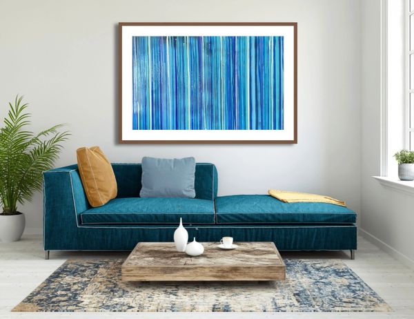 Modern living room with blue sofa and abstract blue artwork.