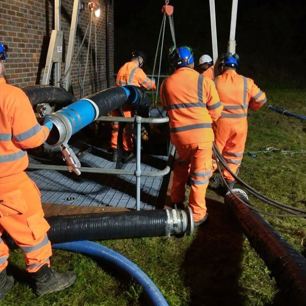 Engineers working on pumping water