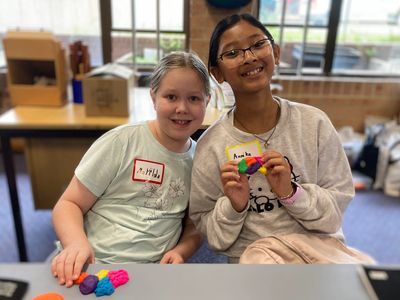 Smiling girls with playdoh brains