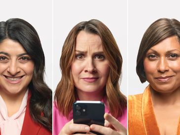 Three women with varying expressions, one holding a phone.
