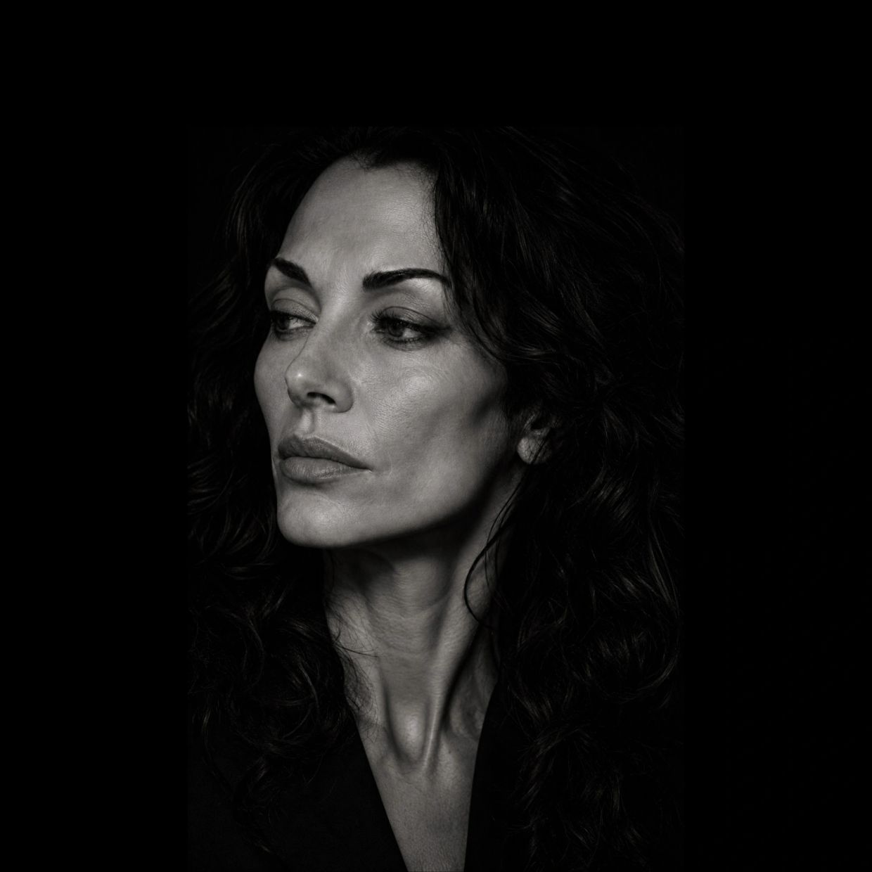 Black and white portrait of a woman looking to the side.