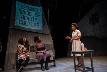 Three women perform a dramatic scene at Desmond School of Beauty Culture.