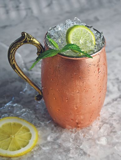 moscow mule in a copper mug with lime, mint, and crushed ice