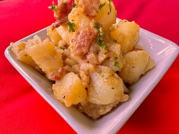 Boiled potatoes tossed with sauteed onions, bacon, and homemade chicken broth, seasoned with special