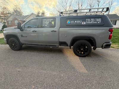Gray pickup truck with business advertisements for Air Works Heating &amp; Cooling.