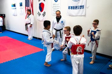 martial arts class with children in red belts