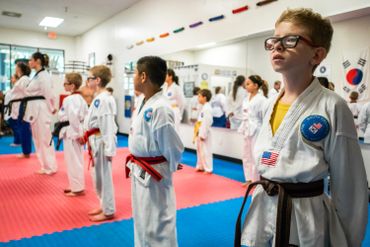 people in martial arts class with different belt levels