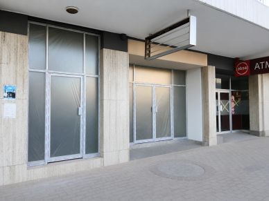 Empty storefront with covered windows and doors.