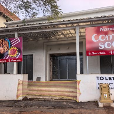 Closed Nando's restaurant with 'Coming Soon' sign.