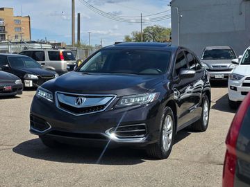 A sleek black Acura SUV parked in a lot on a sunny day.