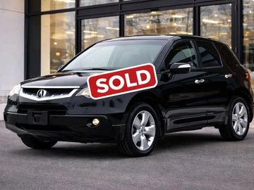 Black Acura SUV with a sold sign on the windshield.