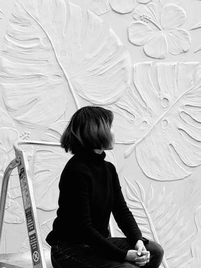 Artist Erica Toh with her donated relief mural at Nourished for Nil’s Queen St. depot in Hastings