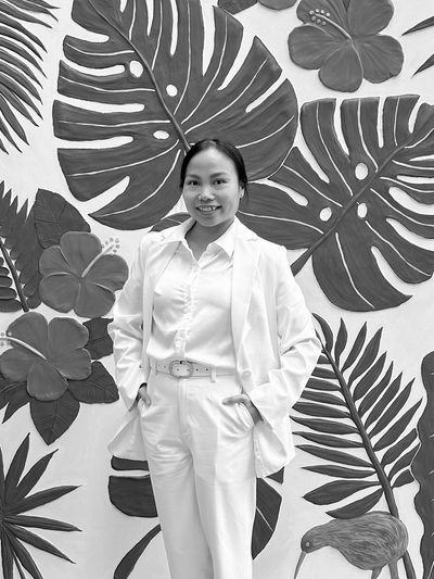 Artist Erica Toh with her donated textured mural at Nourished for Nil’s Queen St. depot in Hastings