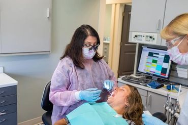 a dentist checking a patients teeth 