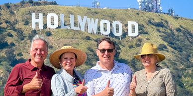 Tourists posed in front of Hollywood Sign