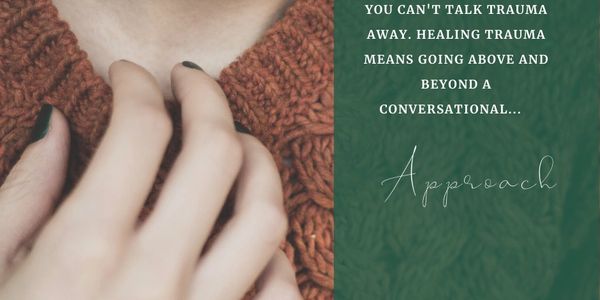 Hand touching a brown knitted sweater with a trauma healing quote.