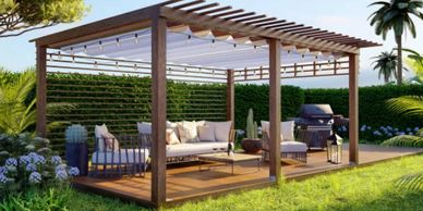 Modern outdoor pergola with cozy seating and a grill in a lush garden.
