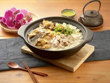 A delicious bowl of Asian chicken soup with herbs and tofu.