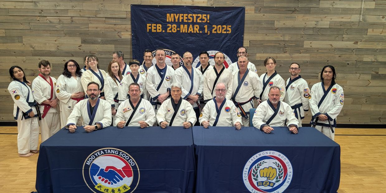 Group photo of martial artists in uniforms at MYFEST25 event.