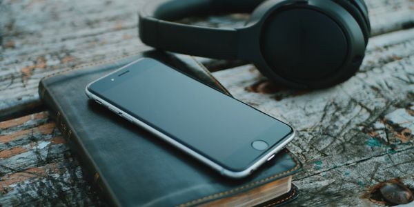 Bible with smartphone and earphones