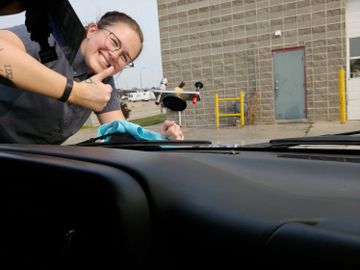 Our repair tech Emma fixing a chip on a customers vehicle