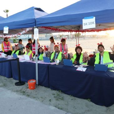 Volunteers at a registration booth for a 5K and 10K event.