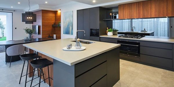 Modern kitchen with black cabinetry and wooden accents.