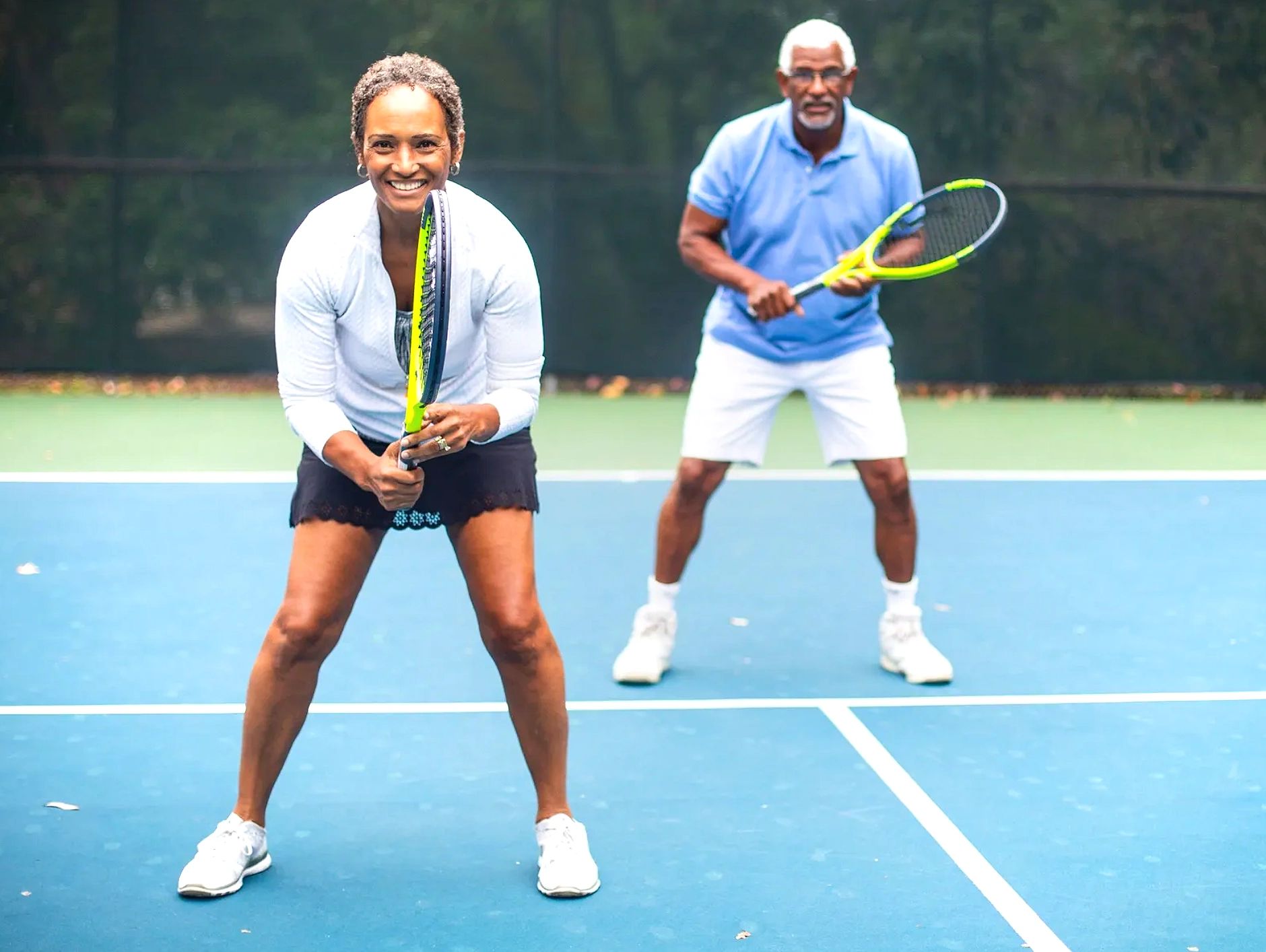 Older couple playing tennis