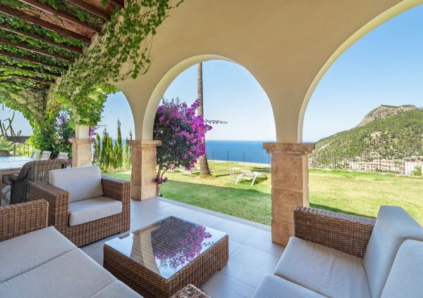 Cozy patio with wicker furniture and ocean view.