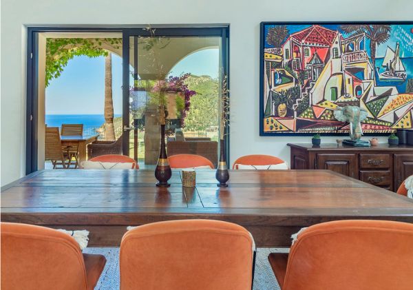 Dining room with sea view and modern art.