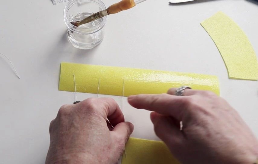 Place the wires on the paper. Place the wires on the paper.