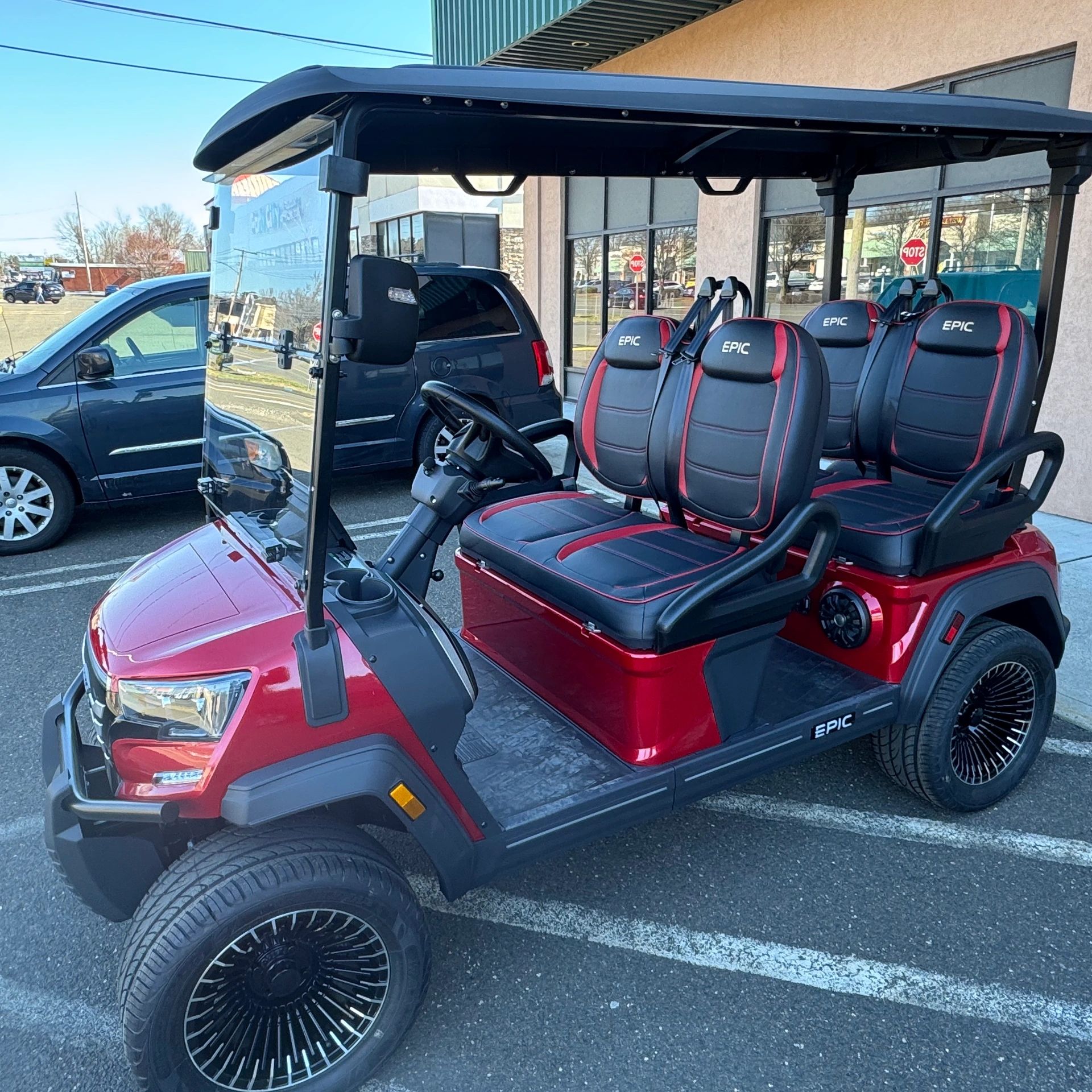 Burgundy E40FX forward-facing 4-seater by EPIC. Colored LED lights, sound system, & many cup holders
