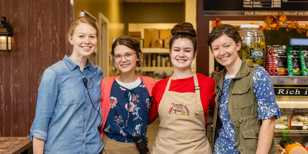 Four people working at a store