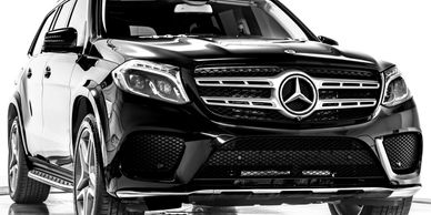 Front view of a sleek black Mercedes-Benz SUV.