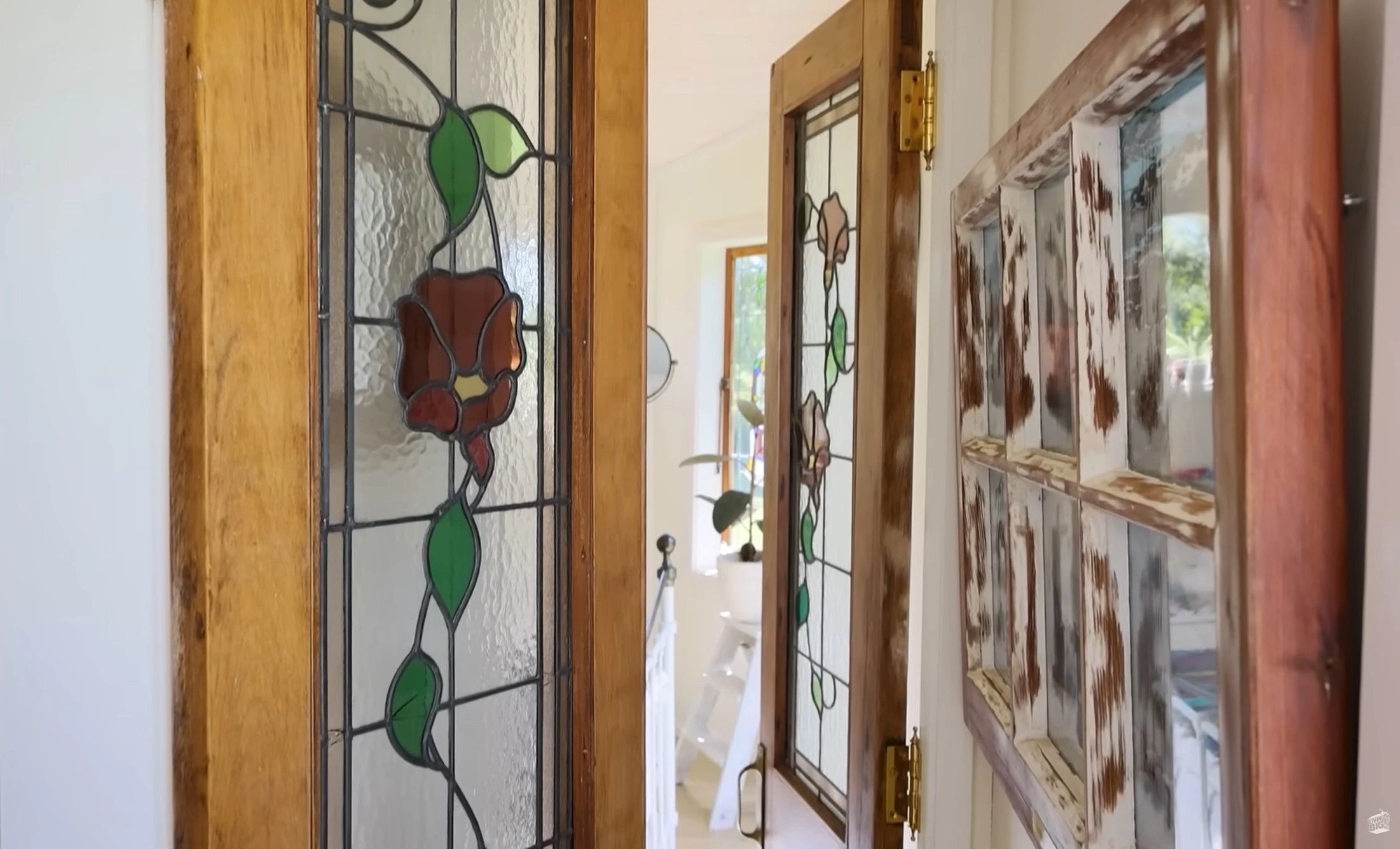 Close-up of wooden doors with stained glass floral designs.